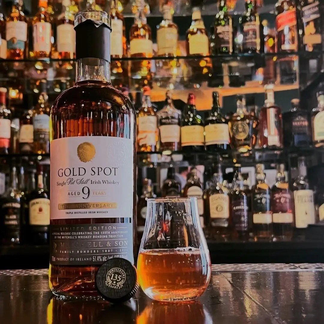 gold spot irish whiskey bottle with taster glass pour - whiskey list